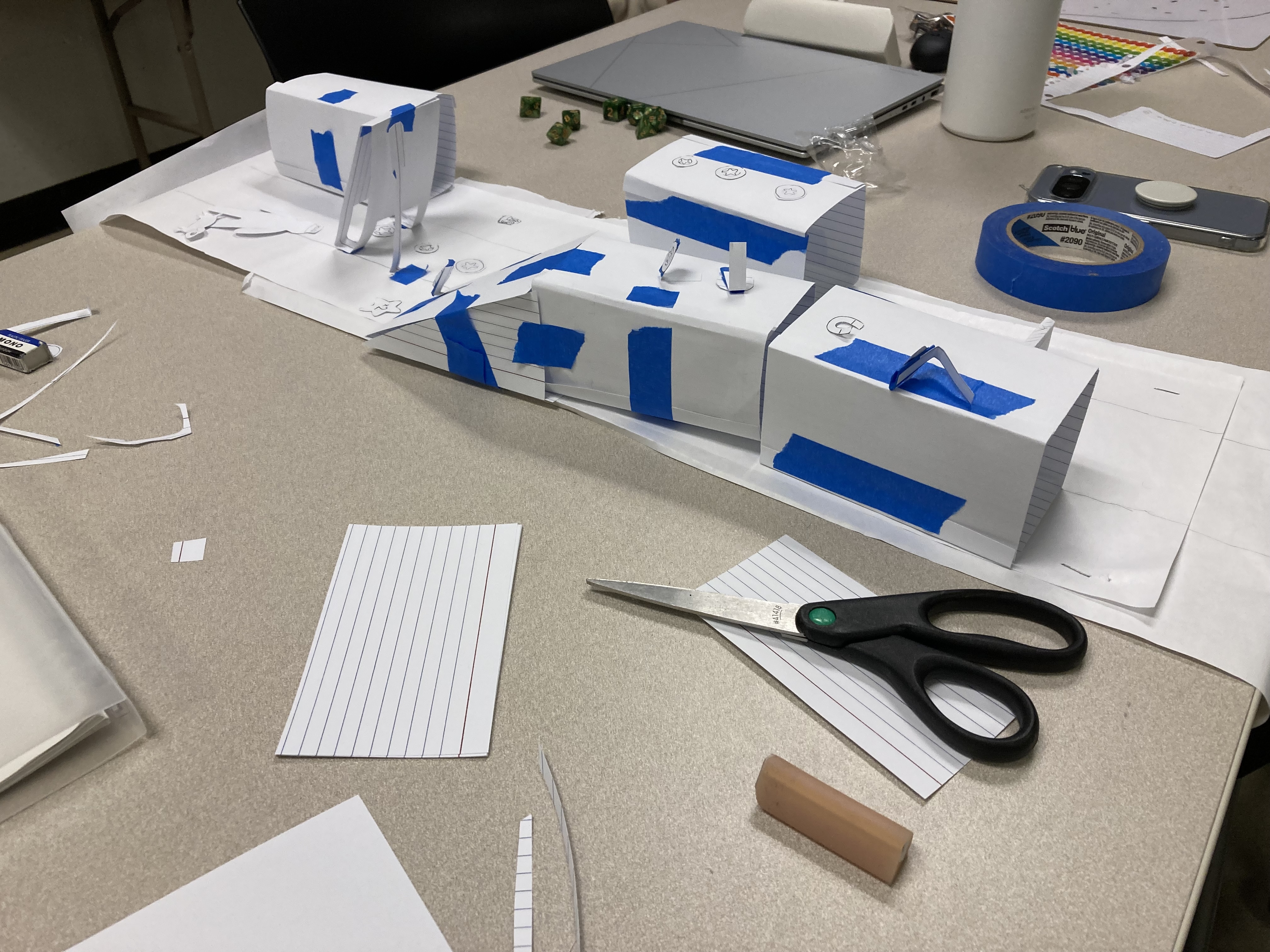 Paper prototype workshop — testing game ideas with cards, dice, and handmade pieces before writing code.